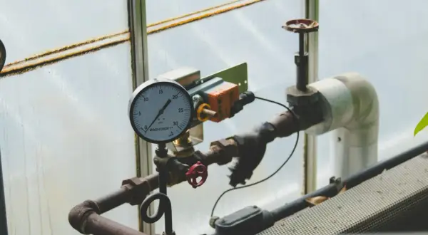 Manometr wskazuje prawidłowe ciśnienie w instalacji solarnej. Rury i zawory są częścią systemu.